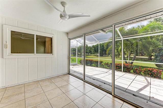 unfurnished sunroom featuring ceiling fan