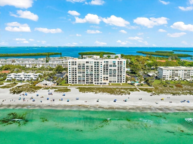 drone / aerial view featuring a water view and a beach view