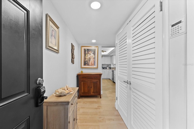 hallway with light hardwood / wood-style floors