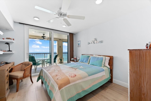 bedroom with expansive windows, access to exterior, ceiling fan, a water view, and light wood-type flooring