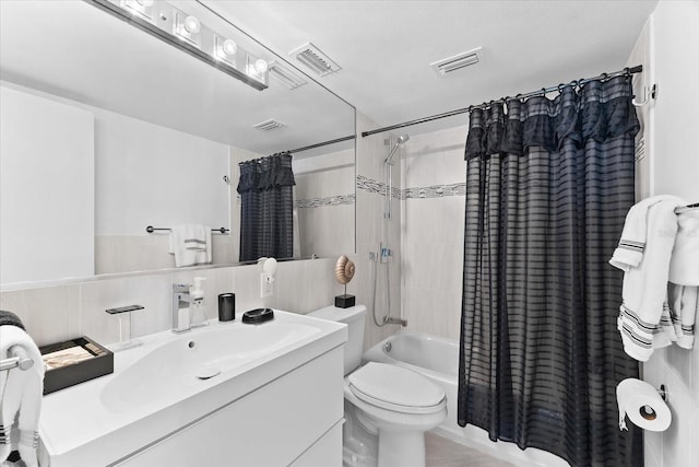 full bathroom featuring shower / tub combo, vanity, and toilet