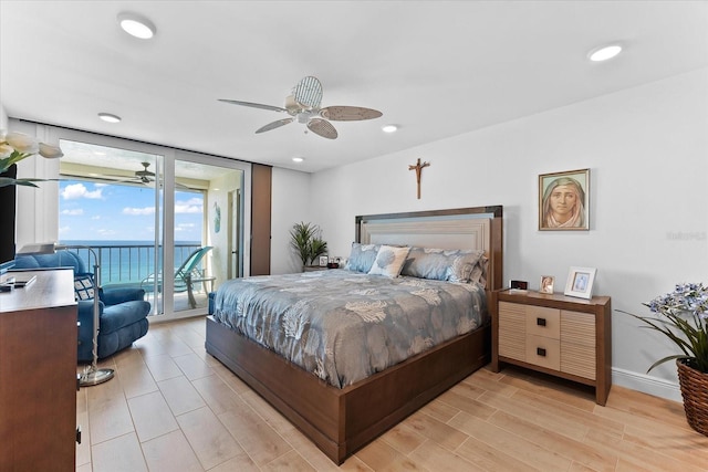 bedroom with access to exterior, expansive windows, ceiling fan, and light hardwood / wood-style flooring