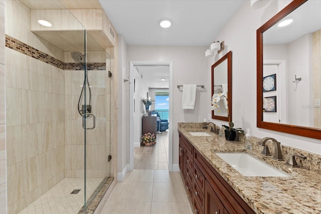 bathroom with walk in shower, tile floors, and dual bowl vanity