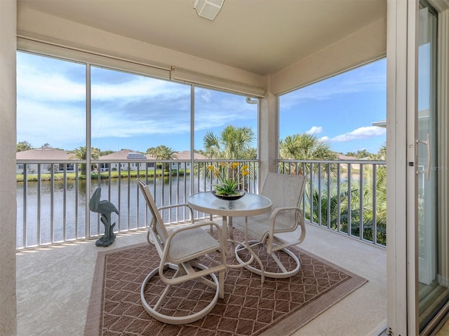 sunroom / solarium with a water view