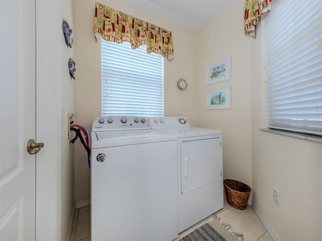 clothes washing area with light tile patterned flooring and independent washer and dryer