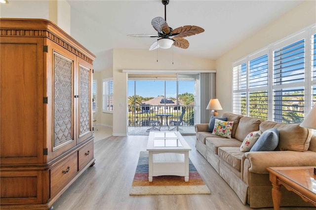 living room featuring ceiling fan, light wood-type flooring, and vaulted ceiling