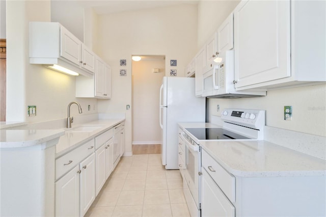 kitchen featuring white appliances, white cabinets, sink, light tile patterned floors, and light stone counters