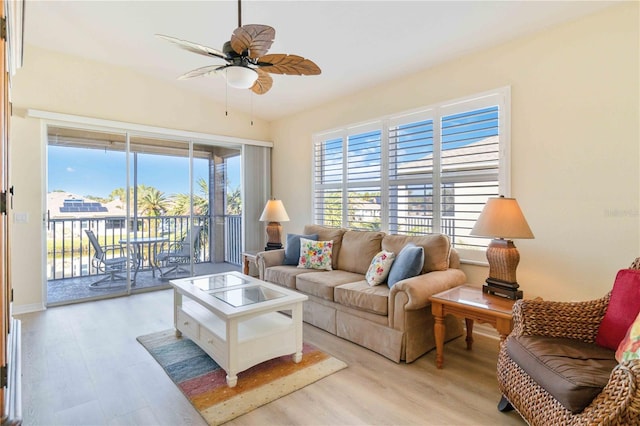 living room featuring ceiling fan and light wood-type flooring