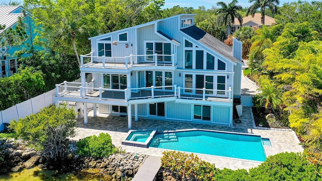 rear view of property with a patio area and a balcony