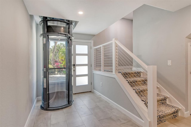 foyer entrance with light tile floors