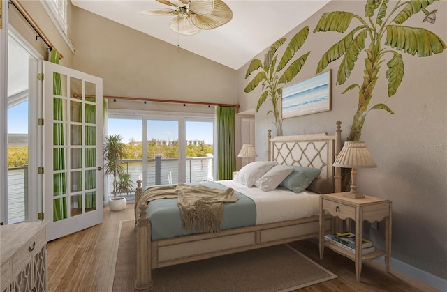 bedroom featuring high vaulted ceiling, dark hardwood / wood-style floors, ceiling fan, and multiple windows