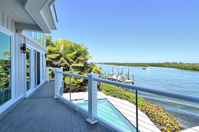 wooden terrace featuring a water view