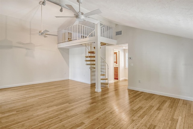 spare room featuring high vaulted ceiling, ceiling fan, and light hardwood / wood-style floors