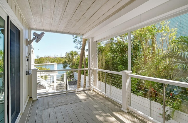 wooden deck featuring a water view