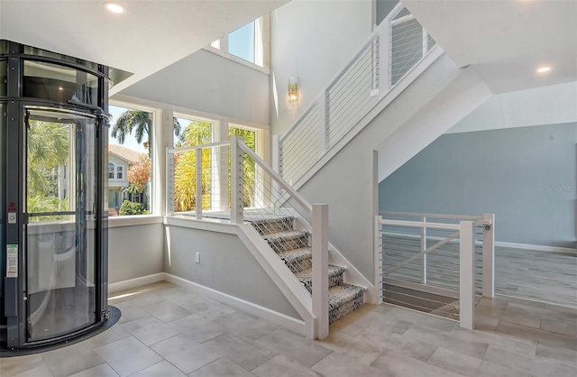 stairway featuring light tile flooring