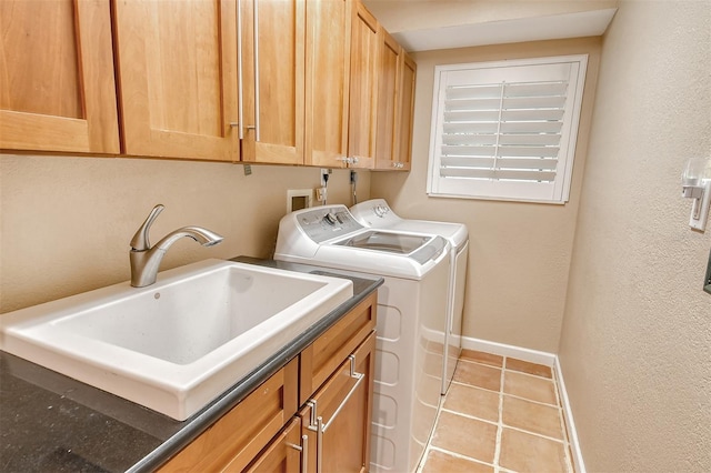 clothes washing area with cabinets, washer and clothes dryer, sink, light tile flooring, and hookup for a washing machine