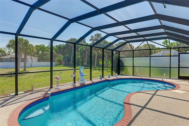 view of pool featuring a lawn, a patio, and a lanai