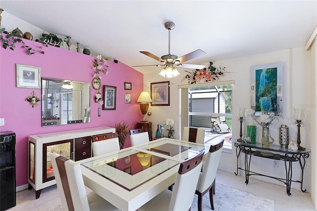 dining space with light tile flooring, vaulted ceiling, and ceiling fan