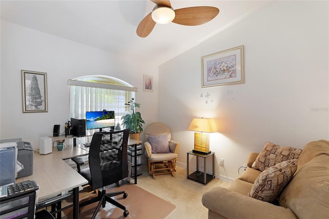 carpeted office with lofted ceiling and ceiling fan