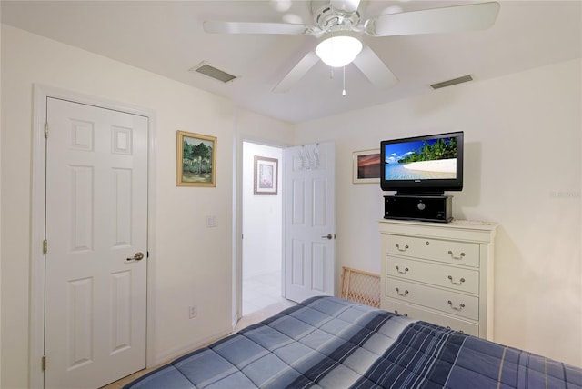 tiled bedroom featuring ceiling fan