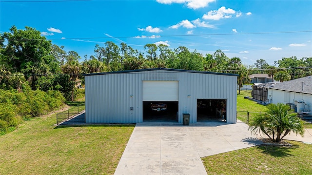 view of outdoor structure with a lawn and a garage