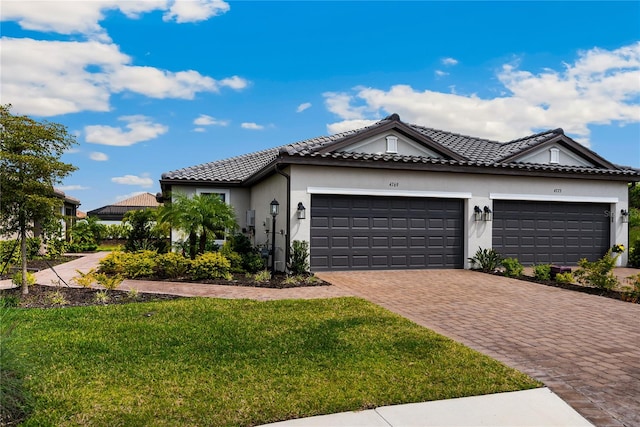 view of front of property with a front yard and a garage