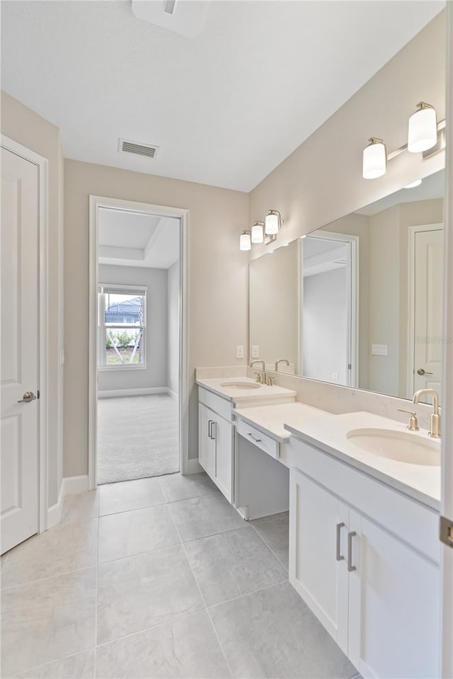 bathroom featuring dual bowl vanity and tile flooring