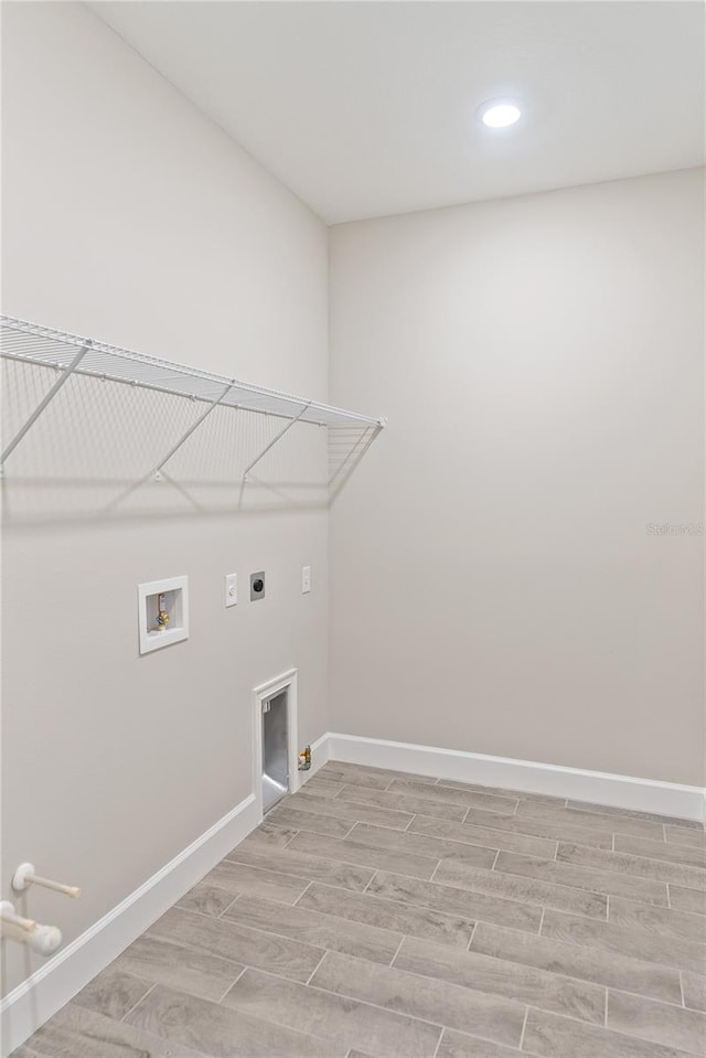 laundry room featuring washer hookup, gas dryer hookup, hookup for an electric dryer, and light hardwood / wood-style floors