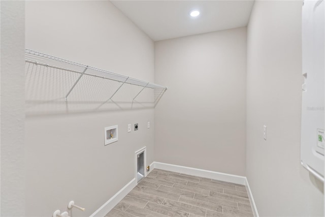 laundry room featuring washer hookup, gas dryer hookup, hookup for an electric dryer, and light hardwood / wood-style floors