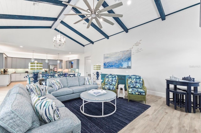 living room featuring ceiling fan with notable chandelier, beam ceiling, light hardwood / wood-style floors, and high vaulted ceiling