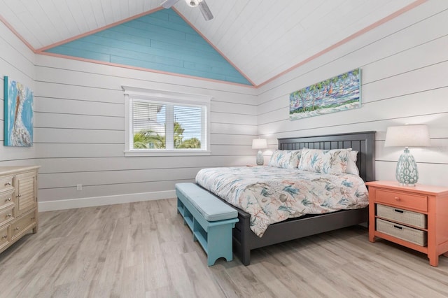 bedroom featuring high vaulted ceiling, wood ceiling, wood walls, and light hardwood / wood-style floors