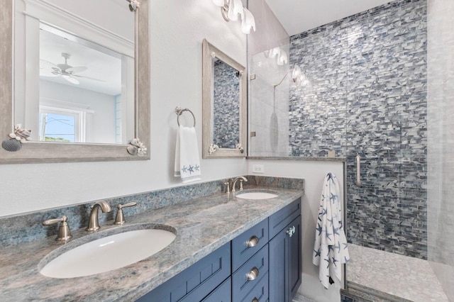 bathroom featuring ceiling fan, vanity, and tiled shower