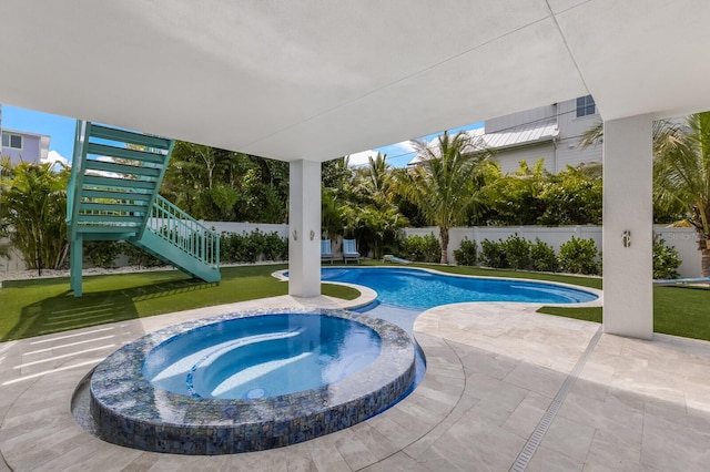 view of swimming pool featuring an in ground hot tub and a patio area