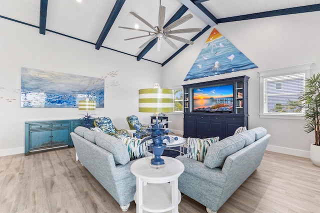 living room with ceiling fan, beamed ceiling, light hardwood / wood-style floors, and high vaulted ceiling