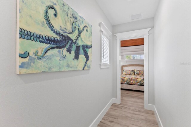 hallway with light hardwood / wood-style flooring