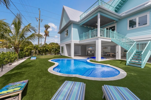 view of swimming pool featuring a yard and a patio area