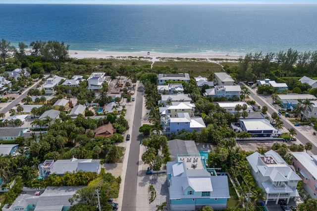 drone / aerial view featuring a beach view and a water view