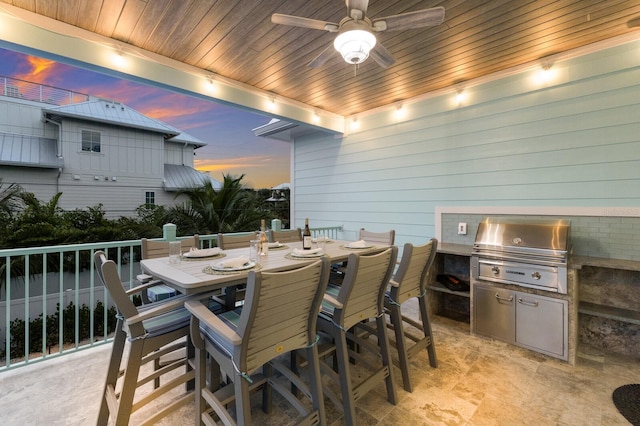 dining area with ceiling fan, wood ceiling, and wood walls