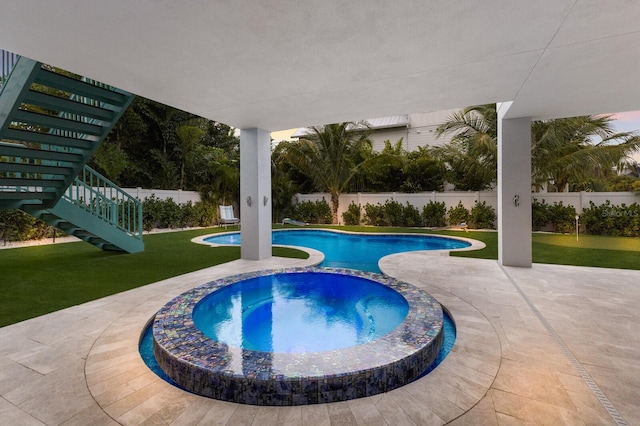 view of swimming pool with a lawn, an in ground hot tub, and a patio area