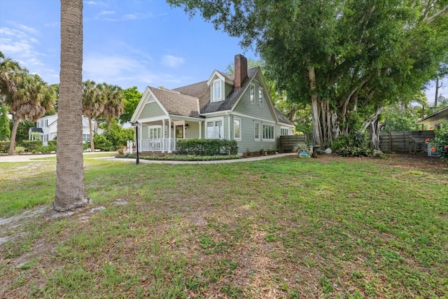 new england style home featuring a front lawn and a porch