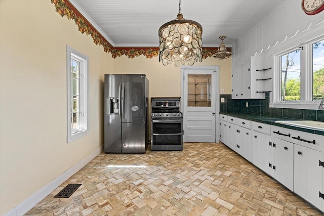 kitchen with pendant lighting, crown molding, a notable chandelier, white cabinetry, and stainless steel appliances