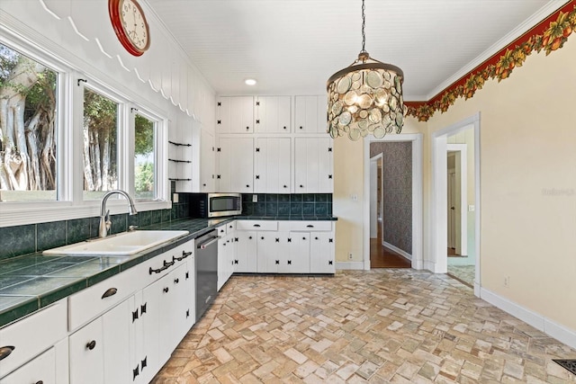 kitchen featuring white cabinetry, hanging light fixtures, stainless steel appliances, tasteful backsplash, and tile countertops