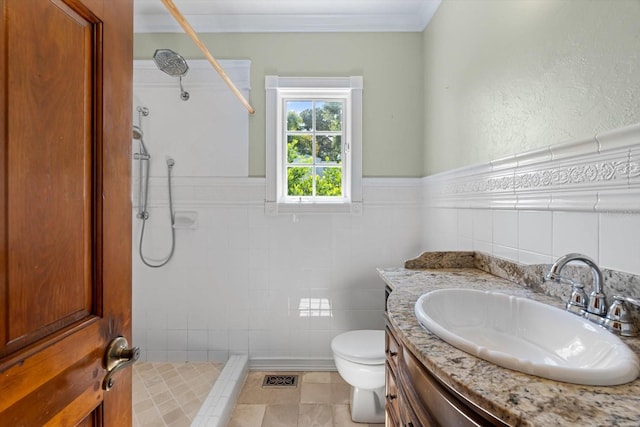 bathroom featuring tile patterned floors, vanity, toilet, and a shower