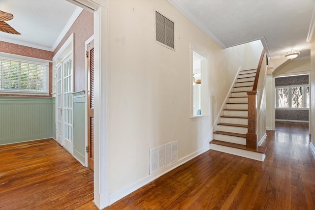 interior space featuring wood-type flooring and ornamental molding