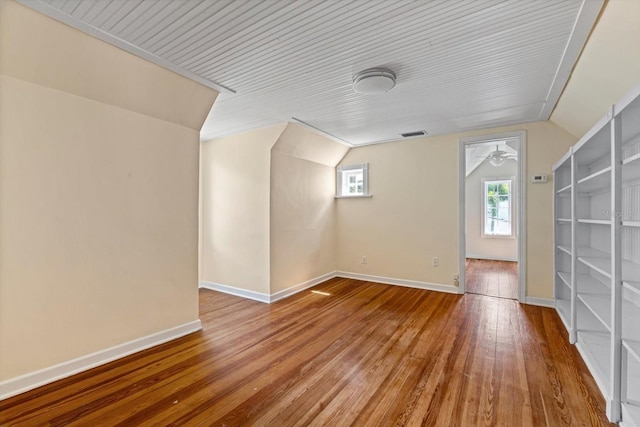 bonus room with ceiling fan, wood-type flooring, and vaulted ceiling