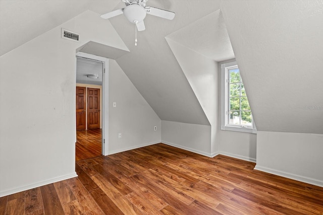 additional living space with wood-type flooring, ceiling fan, and lofted ceiling