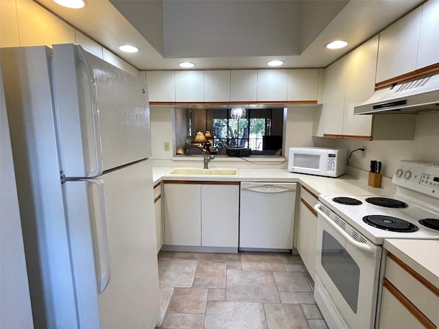 kitchen with white cabinetry, light tile floors, white appliances, and sink