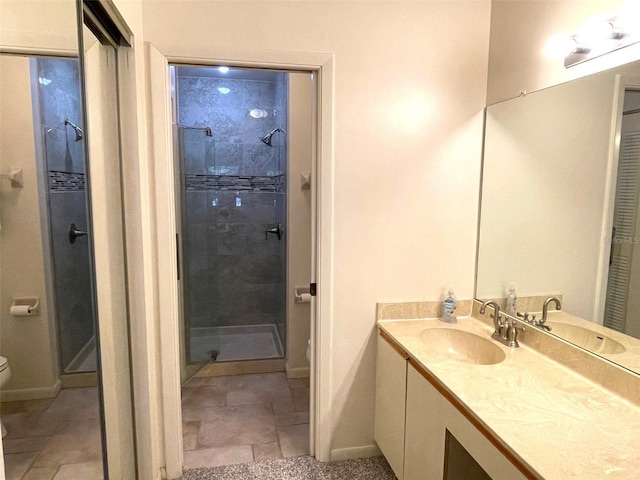 bathroom featuring walk in shower, vanity, tile floors, and toilet