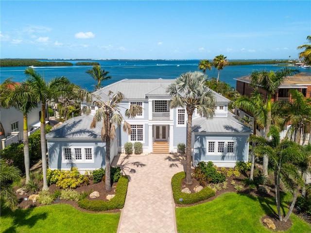 757 Hideaway Bay Dr, Longboat Key, FL 34228 - view of front of property featuring french doors, metal roof, a water view, and a front yard