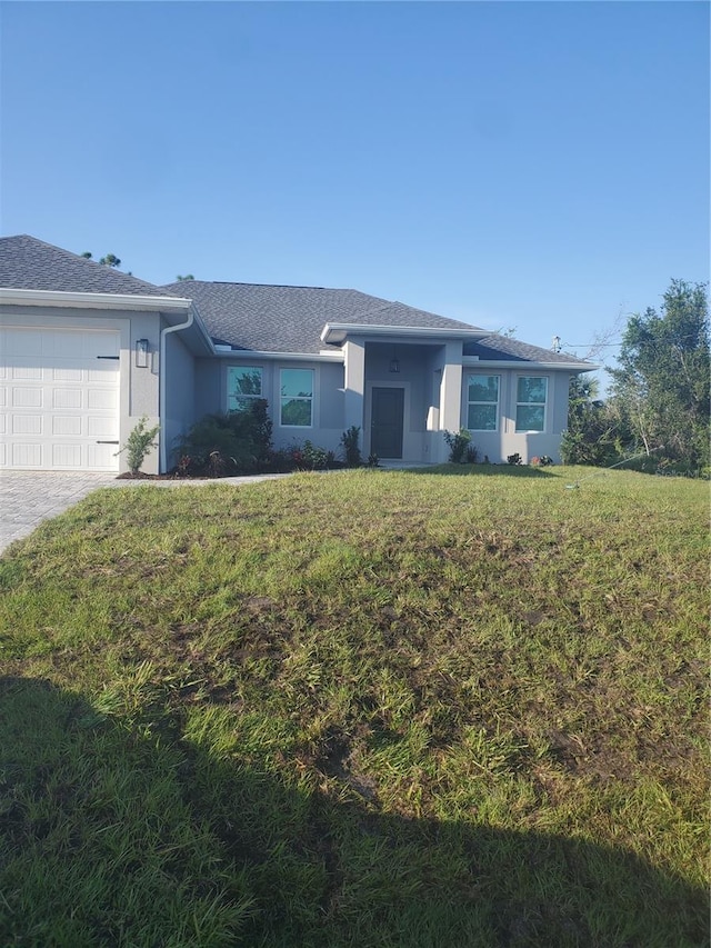 ranch-style home with a front yard and a garage